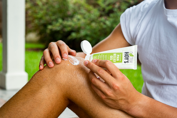 Person using Doctor Hoy’s topical pain relief gel on knee