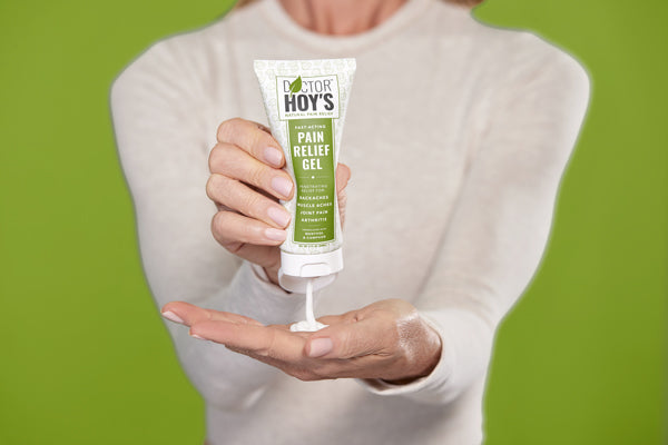 woman squeezing tube of Doctor Hoy’s pain relief gel into hand