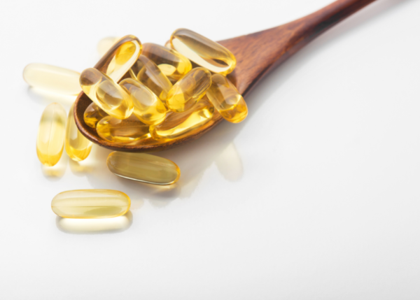 Spoon of yellow fish oil supplements