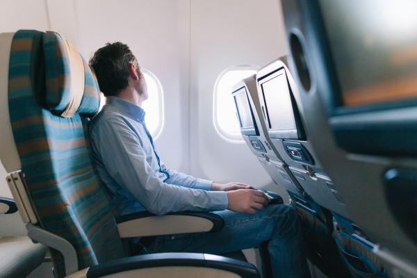 Man sitting on airplane looking out window