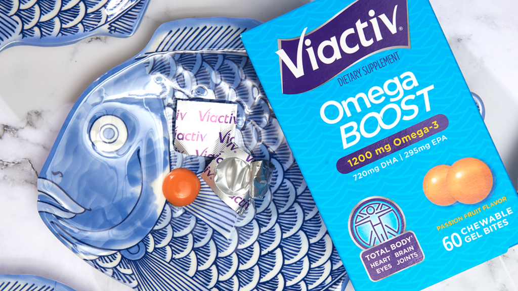 Sustainable Viactiv Omega Boost package over the top of a blue fish plate.