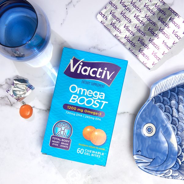 Viactiv Omega Boost Gel Bites next to a beautiful, decorative fish plate