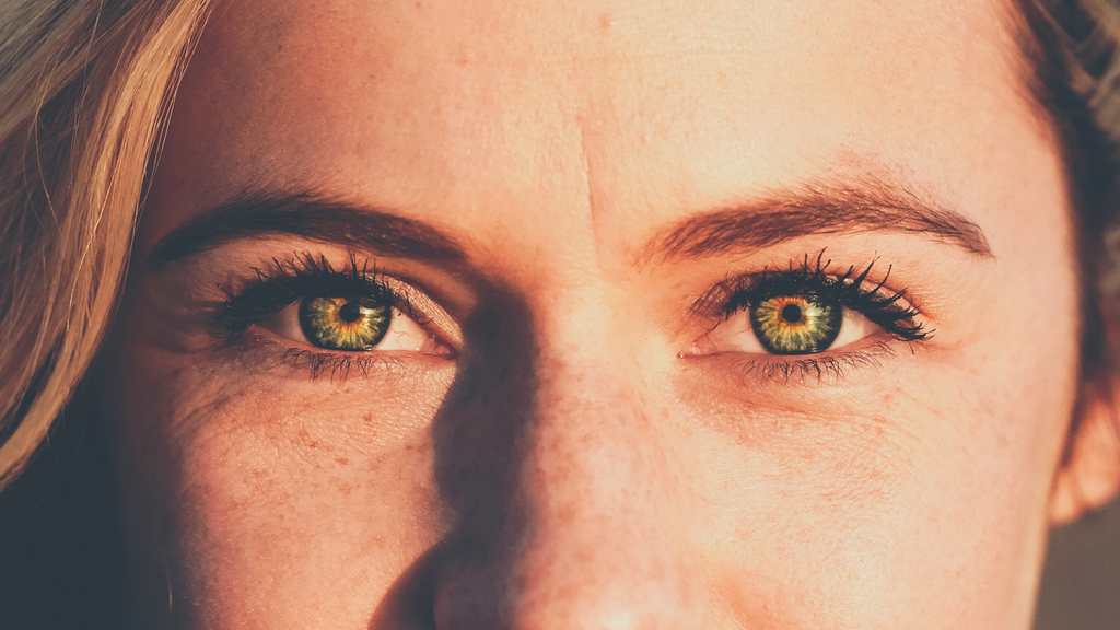 Close up image of woman's blue green eyes