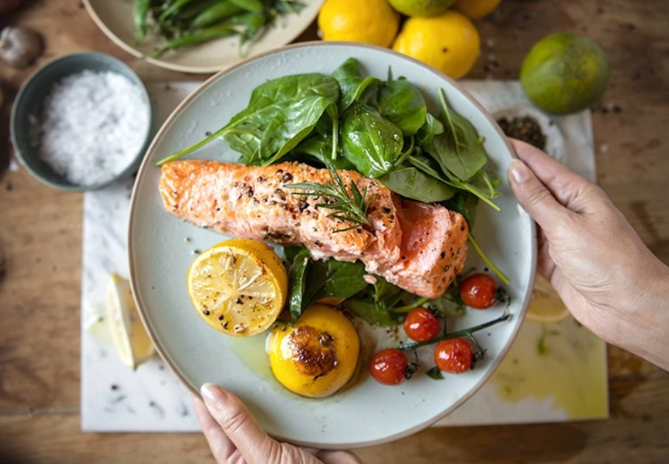 Plate of salmon, full of omega-3s, and vegetables for dinner