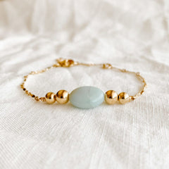 dainty gold filled dapped chain bracelet featuring a soft blue amazonite stone flanked by gold beads