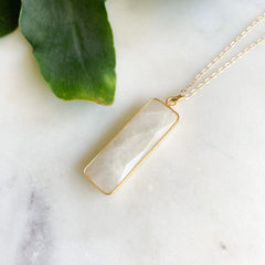 simple minimalist pendant necklace featuring a gold framed linear moonstone pendant 
