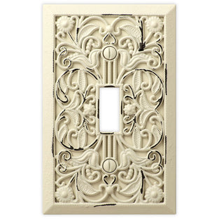 The antique white version of the Filigree collection of Amerelle decorative metal wallplates