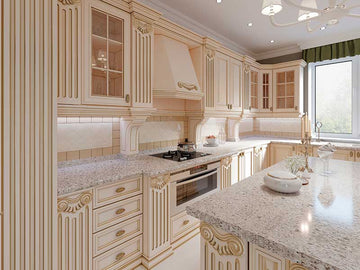 An interior photo of a professionally designed Classical decor style kitchen with cream colored cabinetry, marble countertops, a large window, and a white tile backsplash