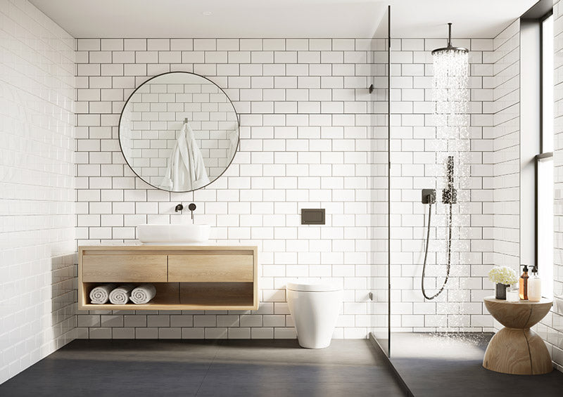 A professionally designed Scandinavian decor style bathroom with white subway tile walls, dark grey floors, a light wood floating countertop and cabinetry, and a modern style shower