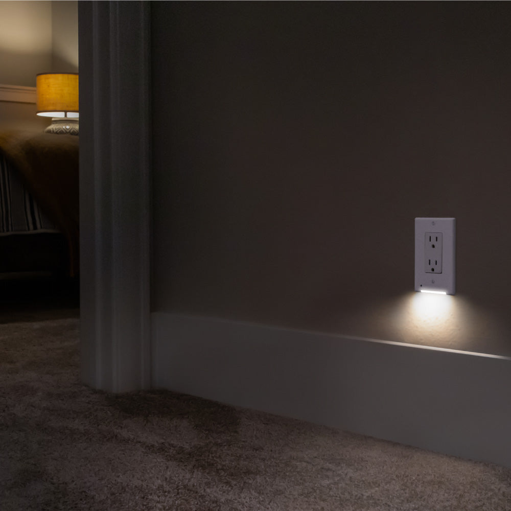 A photo of the classic white decor LumiCover casting light in a hallway at night, with a bedroom in the background