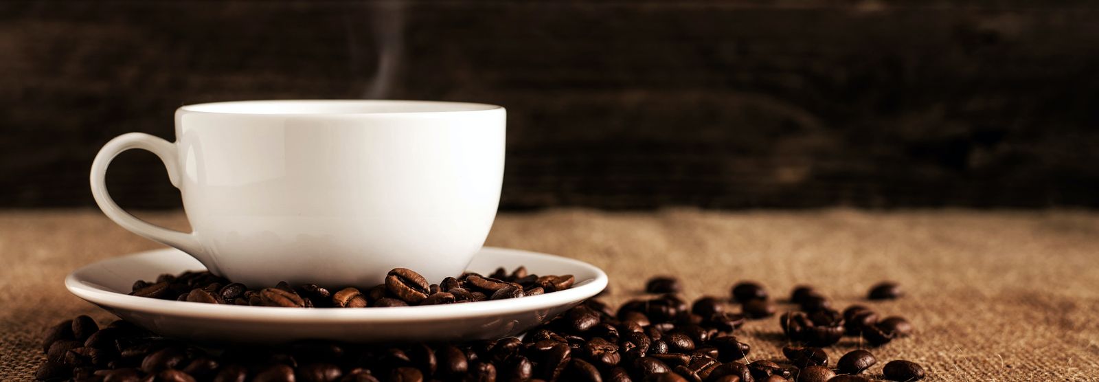 coffee cup with coffee beans around