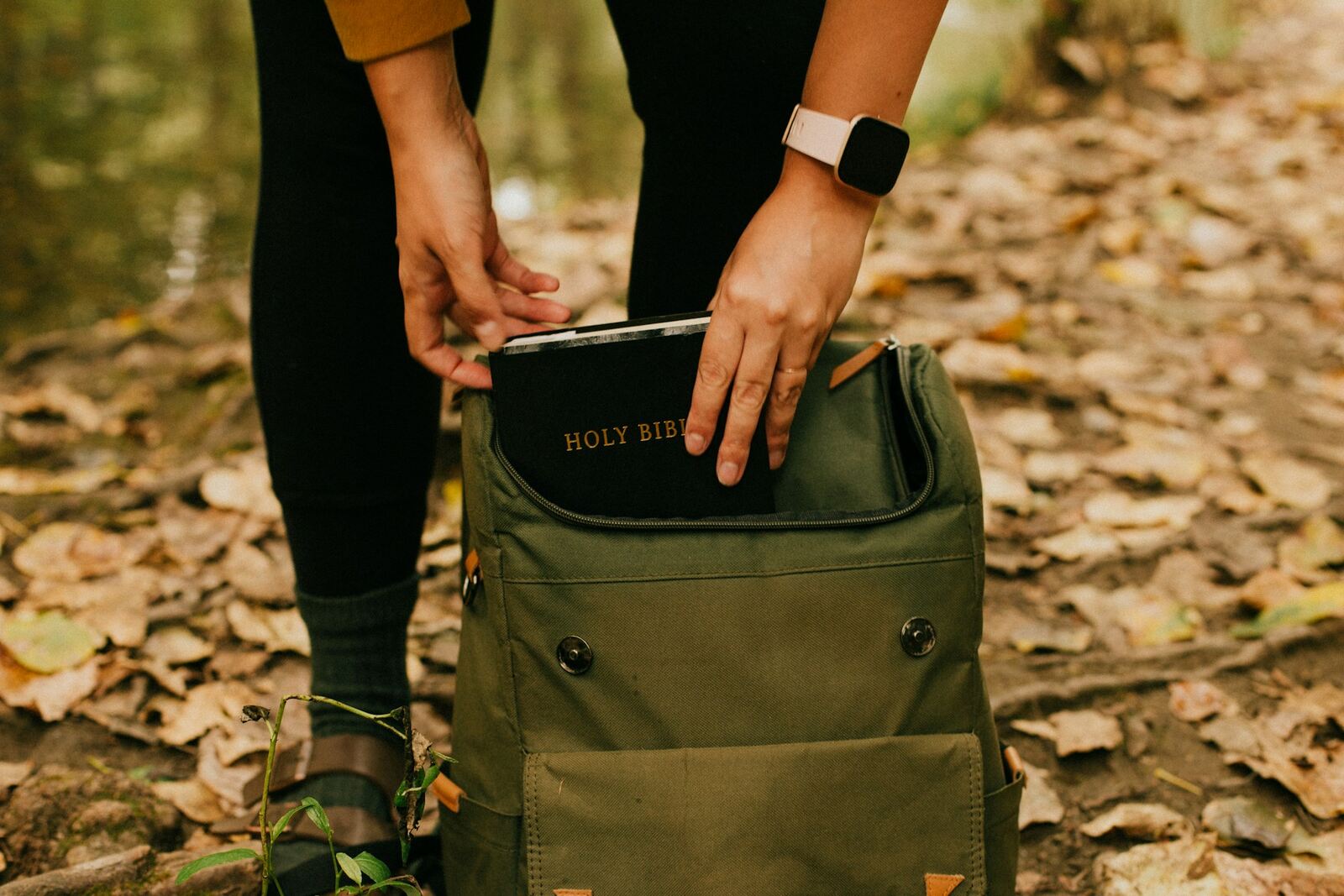 every-day-carry-backpack-man-reaching-in-for-book