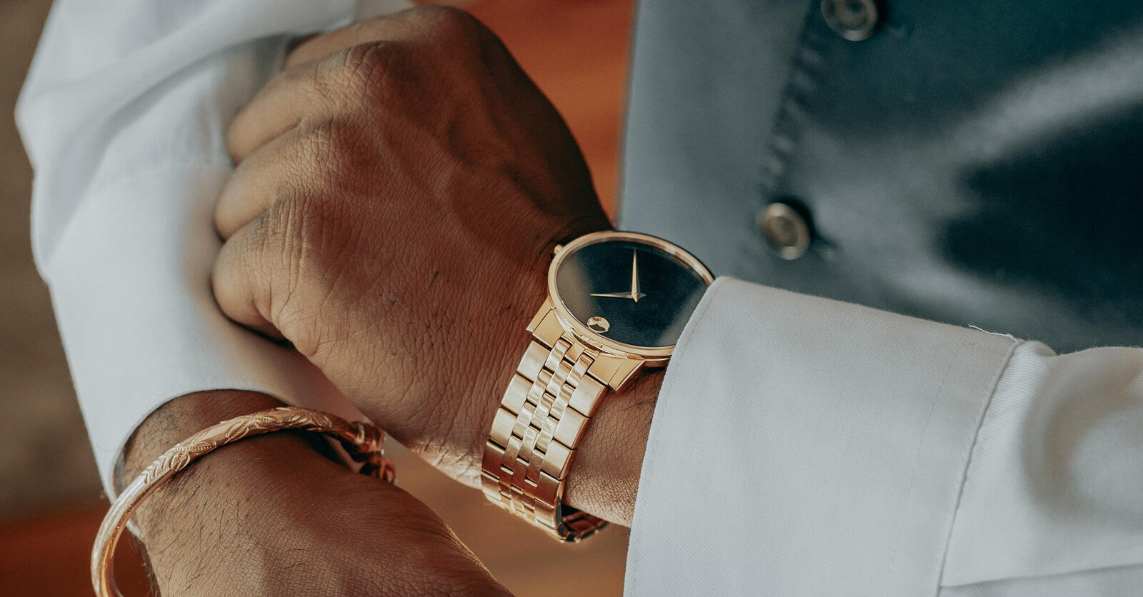 guy in suit with classy movado watch gold