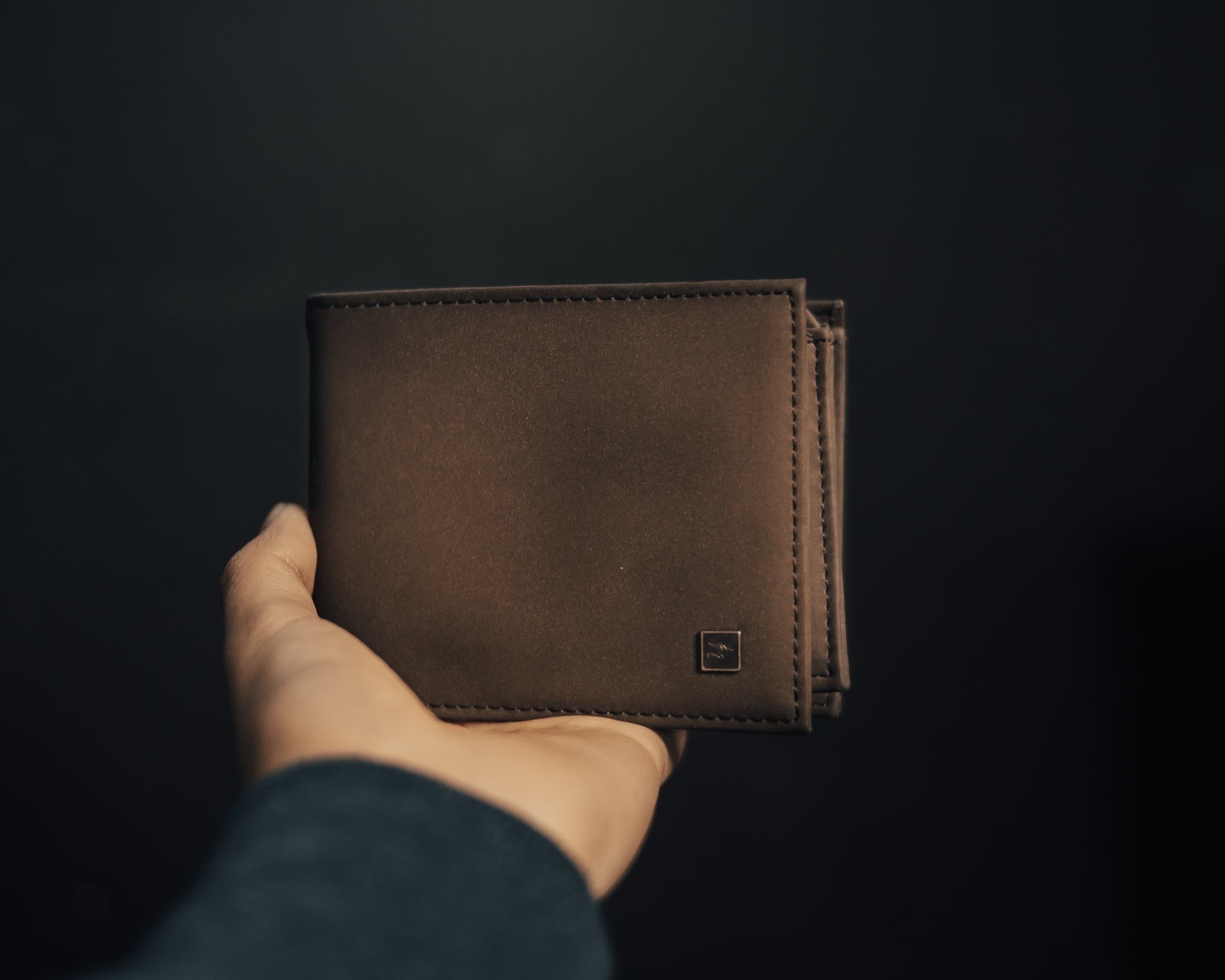 minimal leather wallet in mans hand