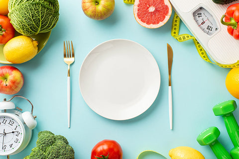empty plate surrounded by healthy food