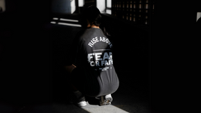 Girl squatting in a black tee