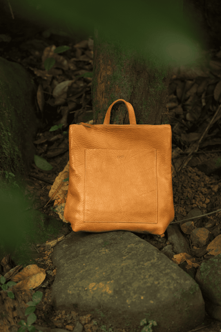 lether backpack in the forest