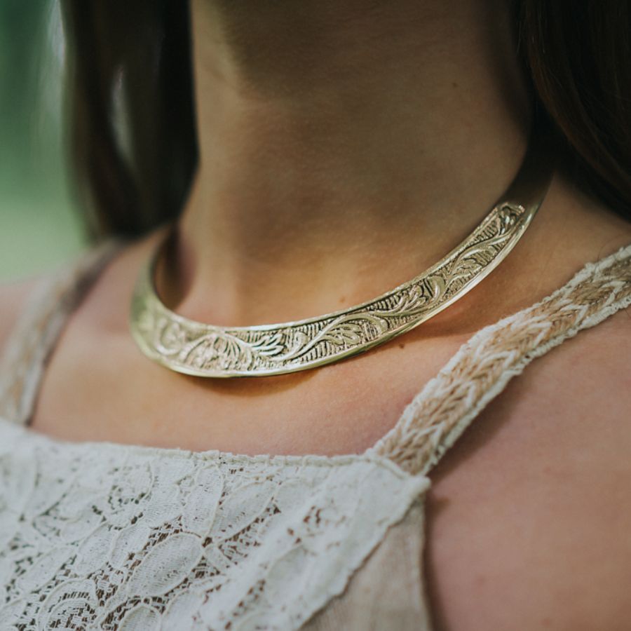 A Celtic torque necklace with traditional knotwork patterns.