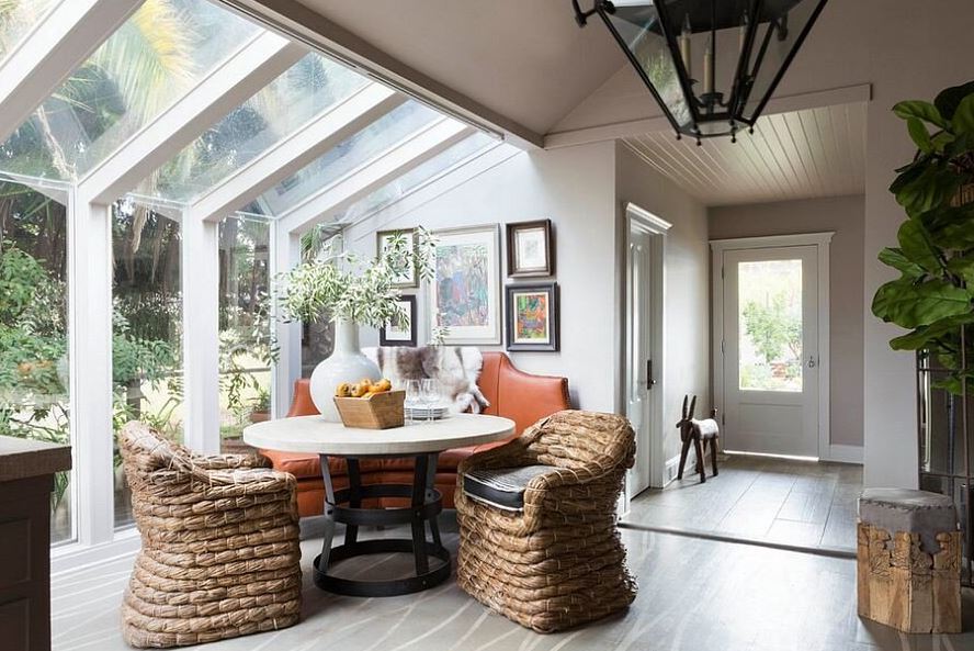 Sun room showing rattan lounge chairs, vinyl sheet flooring, farmhouse chandelier and home decors