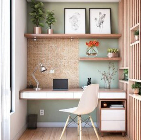Home office with wood table, plastic office chair, wood accents, green wall, wood floor planks, home decors and plants