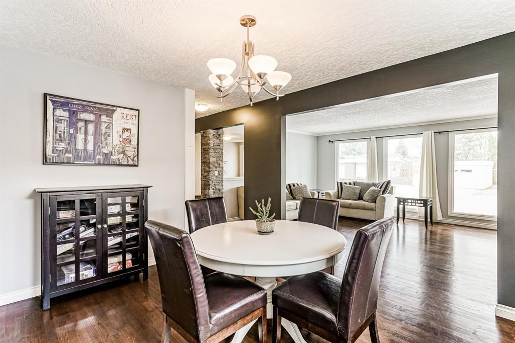 1970 interior design dining area with classic furniture wood floor planks white painted walls and ceiling