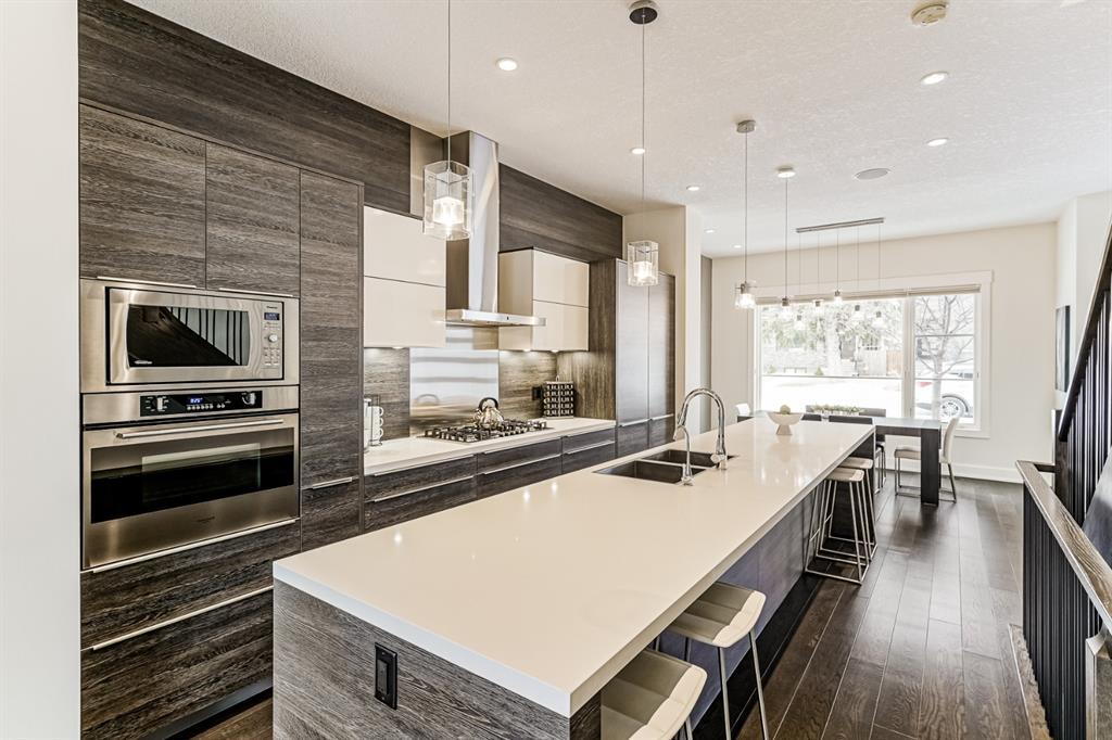 Calgary home listing showing kitchen interior design laminated cabinet white quartz countertop luxury vinyl planks white walls and ceiling 