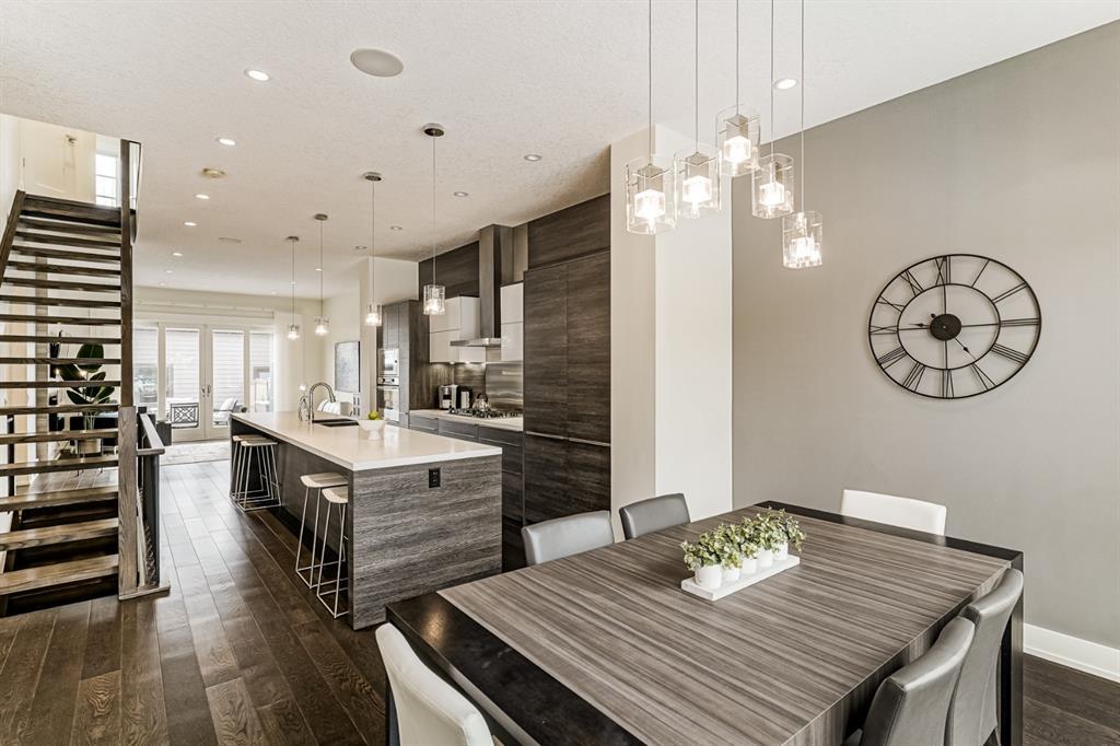 kitchen and dining area white walls and ceiling quartz countertop and luxury vinyl planks