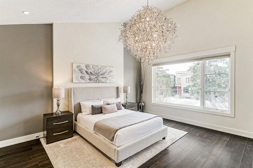 master bedroom interior design with chandelier slanted ceiling brown and white painted walls and ceiling luxury vinyl planks flooring