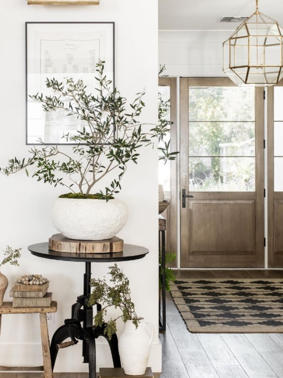 foyer with wooden door and floor and white walls