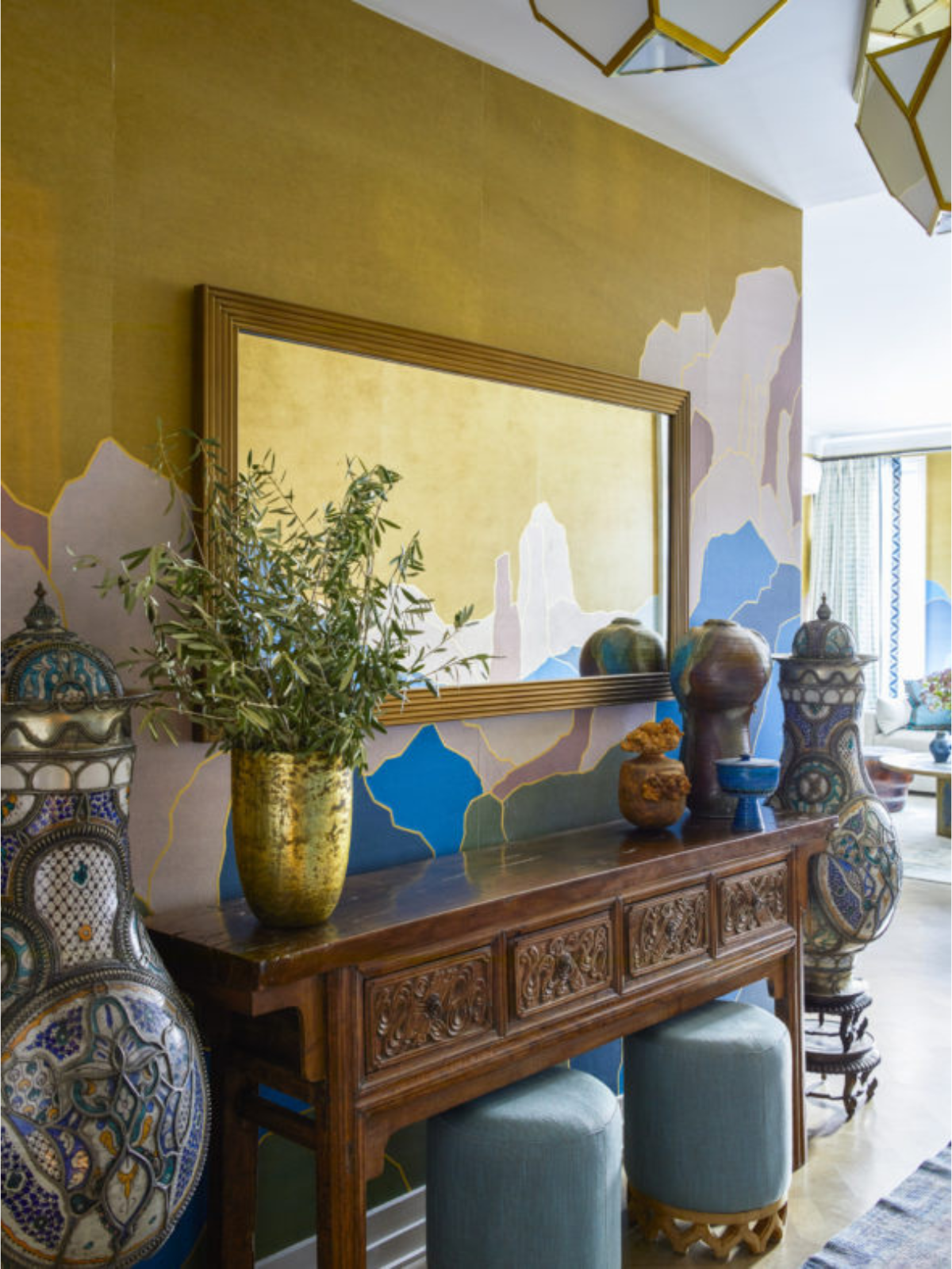 foyer with colorful wallcovering, wooden console table and decors