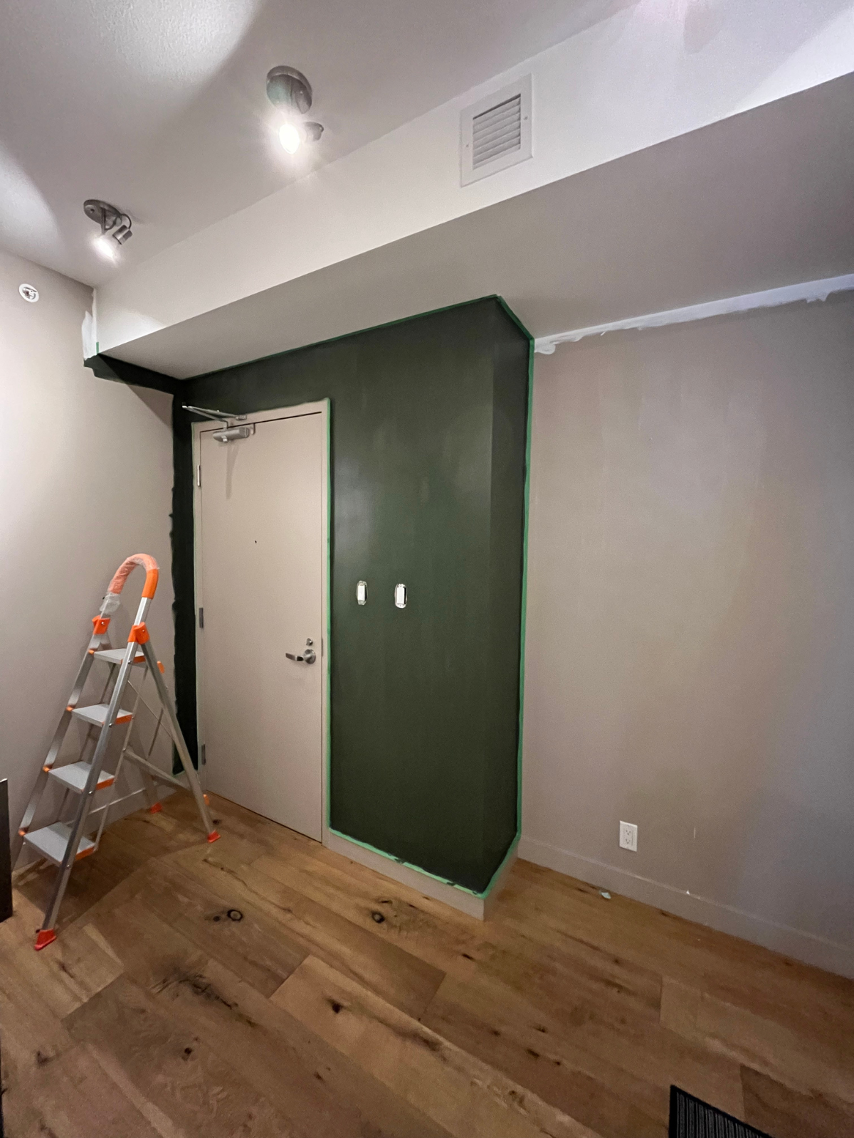 existing foyer space now with green wall paint as accent wall