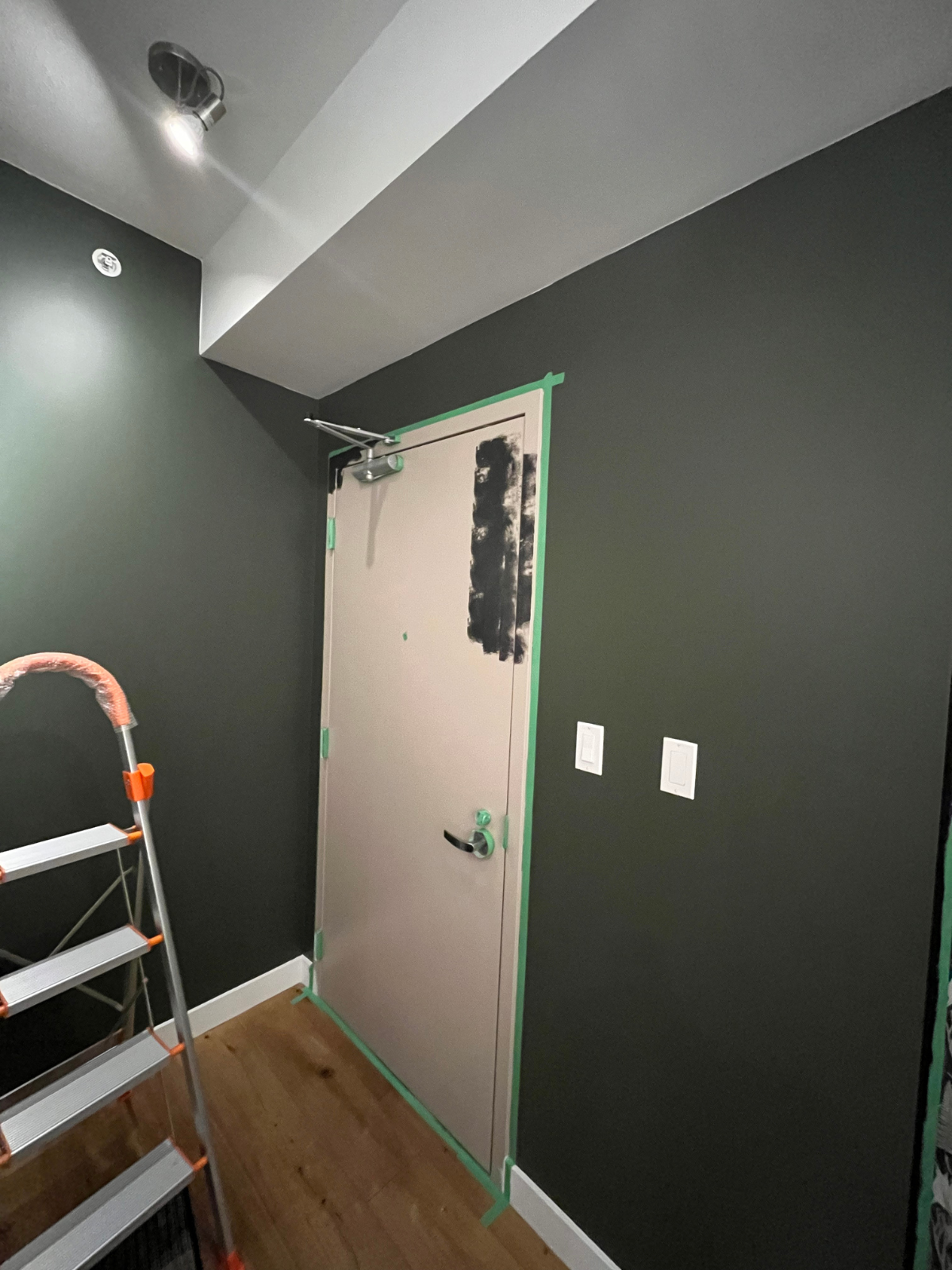 foyer with white and green wall - started to paint the doors black