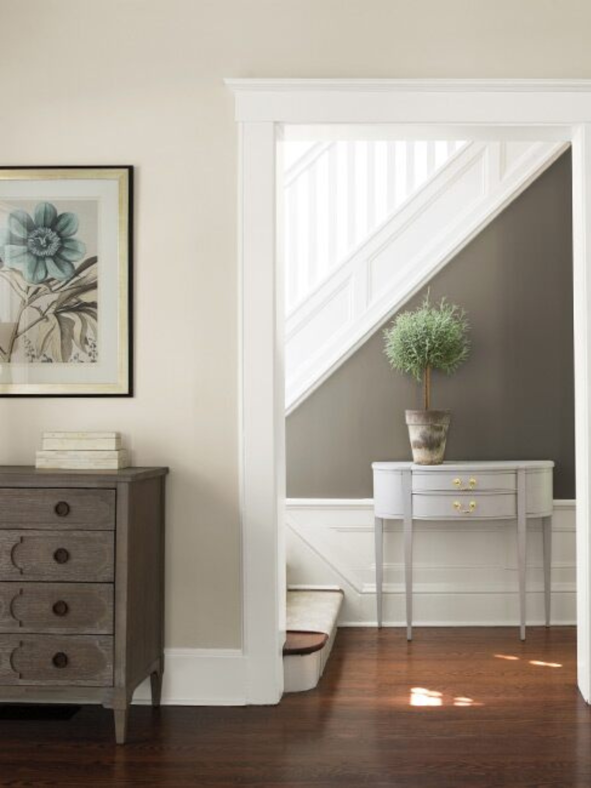 hallway with painted walls, wooden cabinet and console table