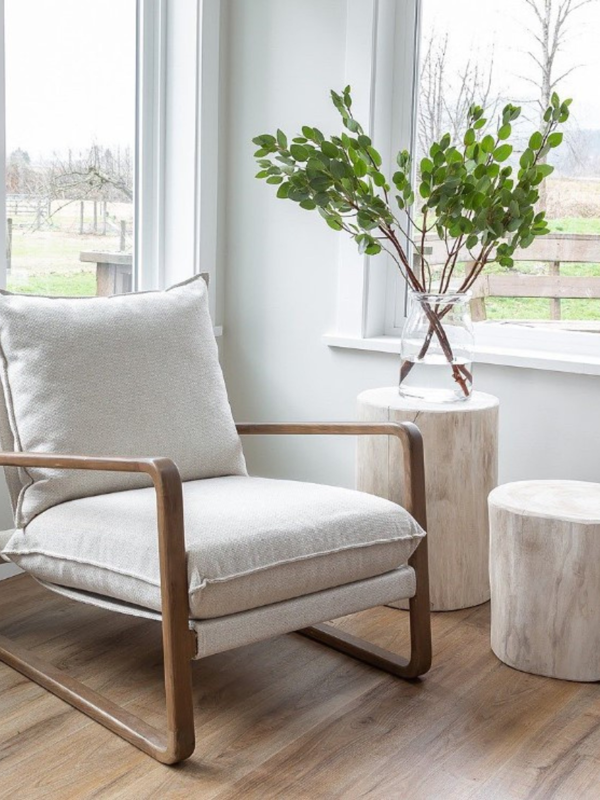 corner reading nook with lounge chair, side tables, indoor plants