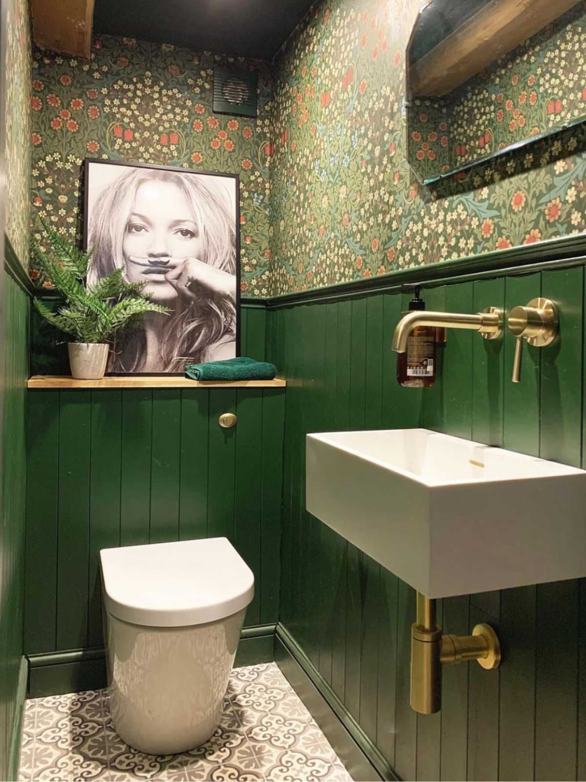 powder room with green painted wainscoting  walls, pattern wallcovering and photography artwork