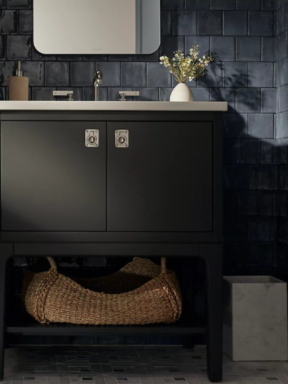 black vanity with metal cabinet door handle, chrome plumbing fixture