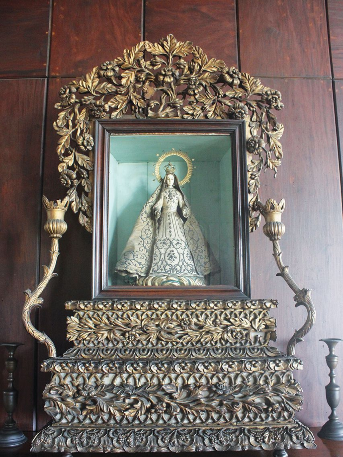 an altar showing a sculpture of mother mary