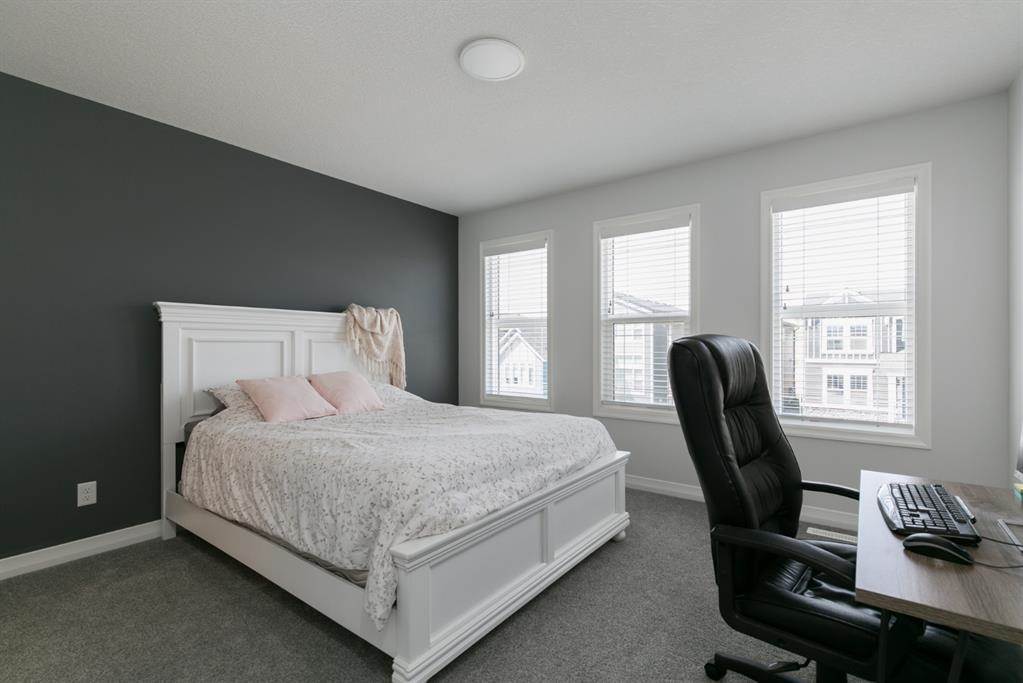 Calgary home listing interior design bedroom with grey wall and white painted wall and carpeted flooring