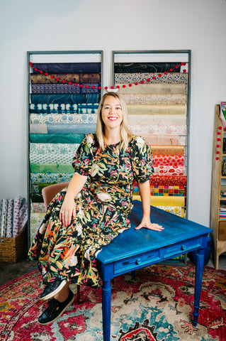 Casey and her beloved paper rack with handmade and hand marbled papers from around the globe!