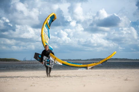 Kiter walking up beach