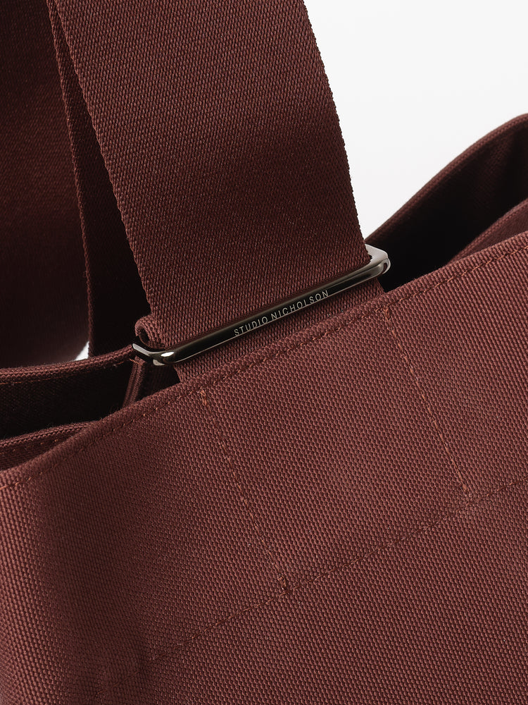 SLIDE CANVAS CROSS BODY BAG IN CHESTNUT