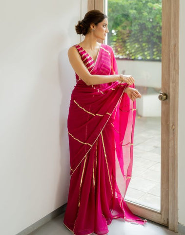 magenta color saree with intricate detailing