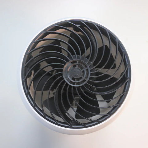 A Senelux air purifier from the top down, showing the extraction fan which is all black compared to the white background.