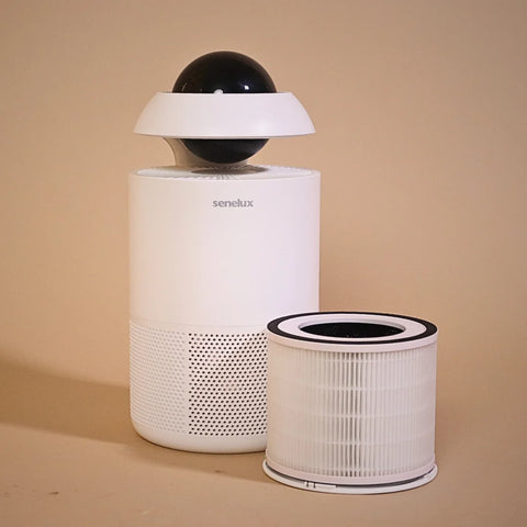 A picture of the Senelux Jupiter Air Purifier with it's filter standing next to it with a warm, orange background