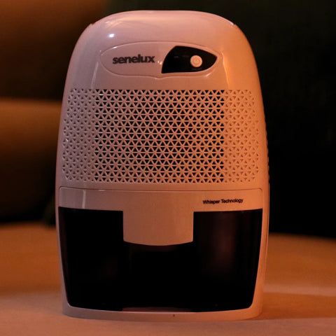 A close up picture of a Senelux Mini Dehumidifier with a dark background
