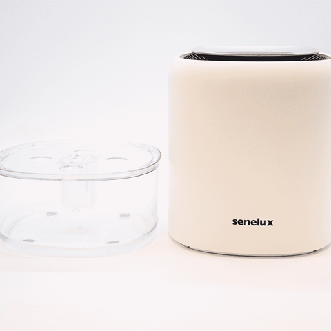 A Senelux Q4 Dehumidifier set against a white background. The Senelux Q4 dehumidifier is broken down into its two core components; the main body and the water tank- displaying the product's easy-clean features.