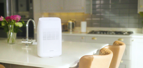 A Senelux T8 750ml dehumidifier in the middle of a brand new kitchen with sparkling marble counter tops