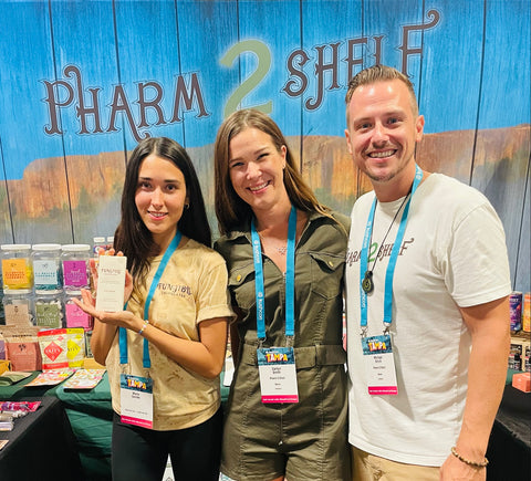 Maria Garces (founder of Fungible Chocolates) , Caitlyn Smith, and Michael Smith (Pharm2Shelf Owners & Operators) standing together at KushCon 2022