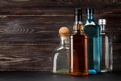alcohol bottles laying on a wooden table