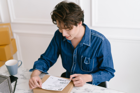 man placing label on box